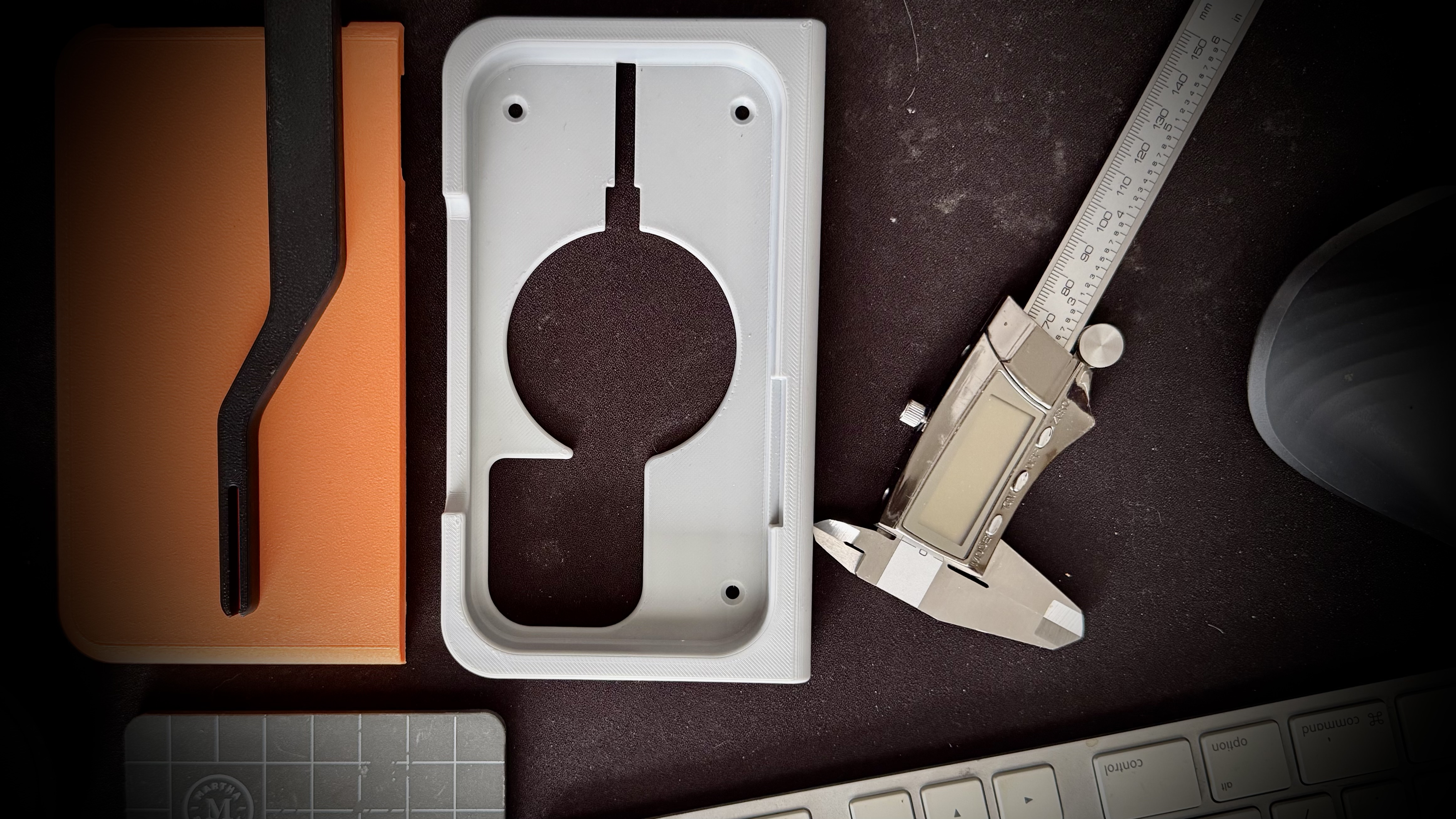3D printed prototype with digital calipers on design workspace